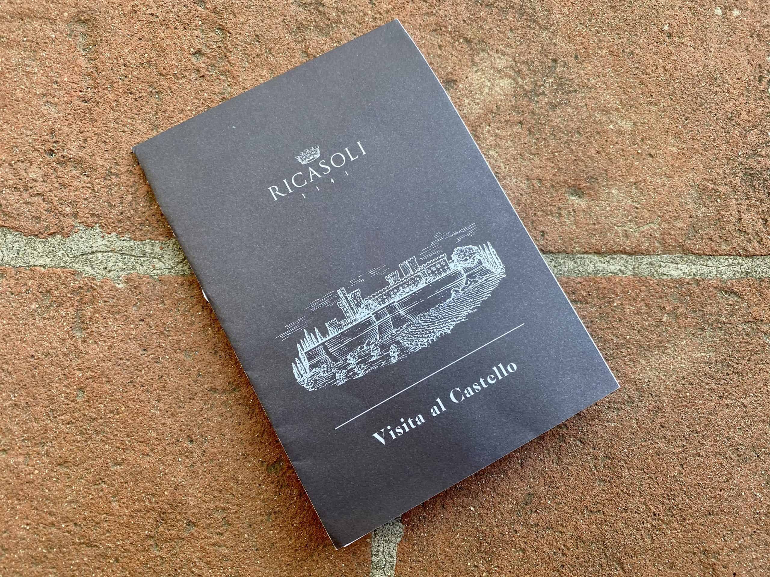 Visitor's pamphlet for Castello di Brolio (Brolio Castle), sitting on terracotta bricks.